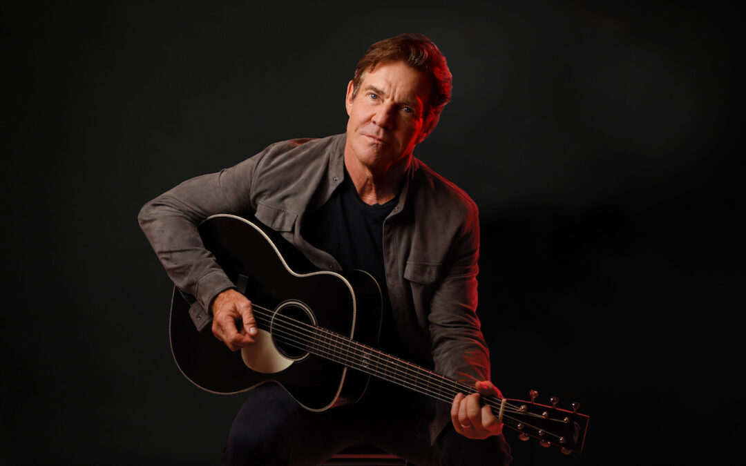 Photo of Dennis Quaid with a guitar